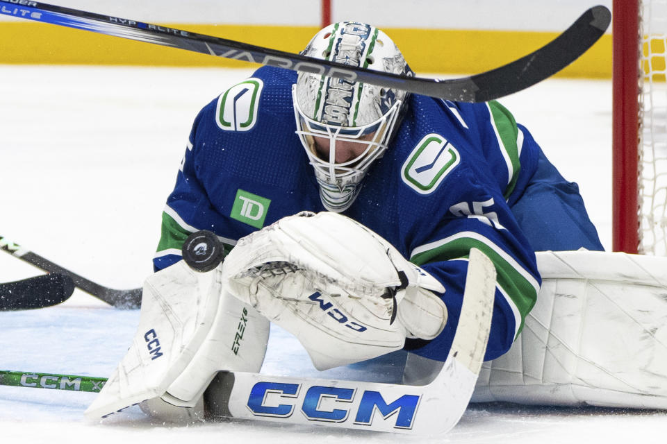 Vancouver Canucks goaltender Thatcher Demko stops the puck during the third period of the team's NHL hockey game against the Seattle Kraken on Saturday, Nov. 18, 2023, in Vancouver, British Columbia. (Ethan Cairns/The Canadian Press via AP)