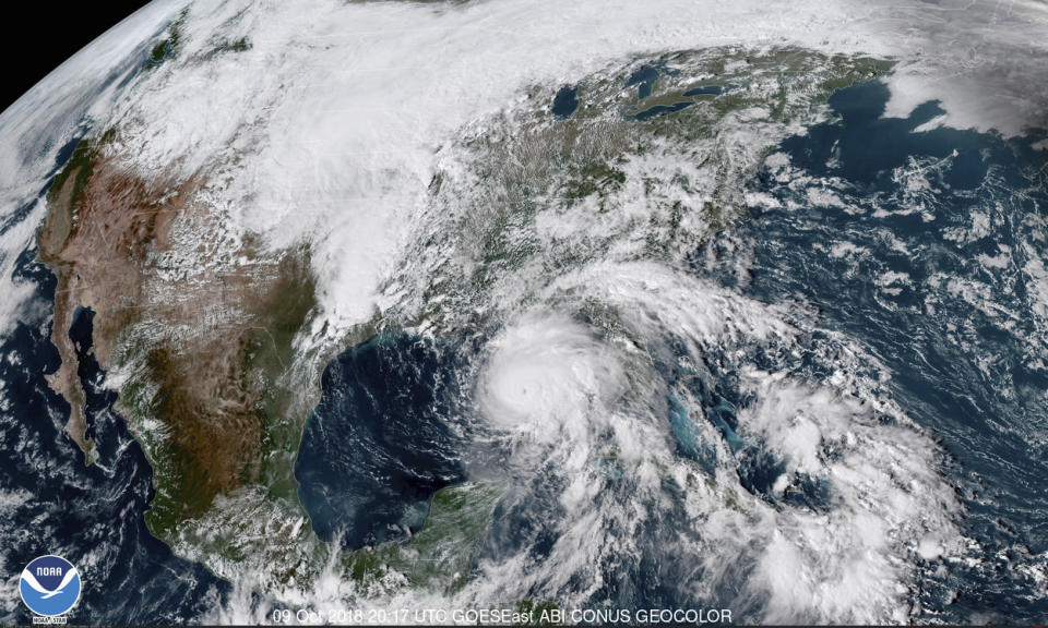 FILE - This Oct. 9, 2018, file photo shows a satellite image made available by NOAA showing Hurricane Michael, center, in the Gulf of Mexico. Hundreds of residents in the county hardest hit by Hurricane Michael are losing housing vouchers that allowed them to stay at hotels in the aftermath of the Category 4 storm. Around 250 households in Bay County, Florida, are facing eviction from hotels Tuesday, April 9, 2019 since their vouchers from the Federal Emergency Management Agency’s Transitional Sheltering Assistance program were ending. (NOAA via AP, File)