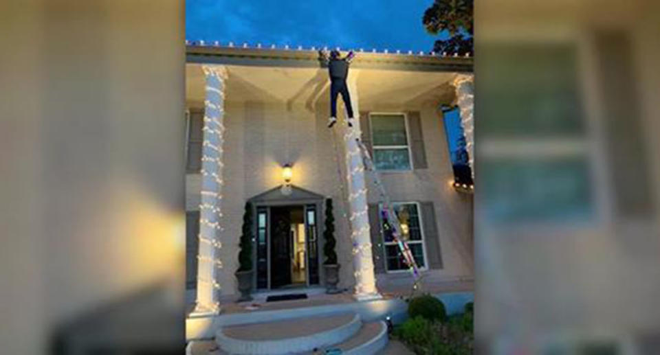 A Texas family’s National Lampoon Christmas Vacation-inspired light display sent a passerby into a panic, thinking a man was really hanging off the roof of a home. Source: Chris Heerlein
