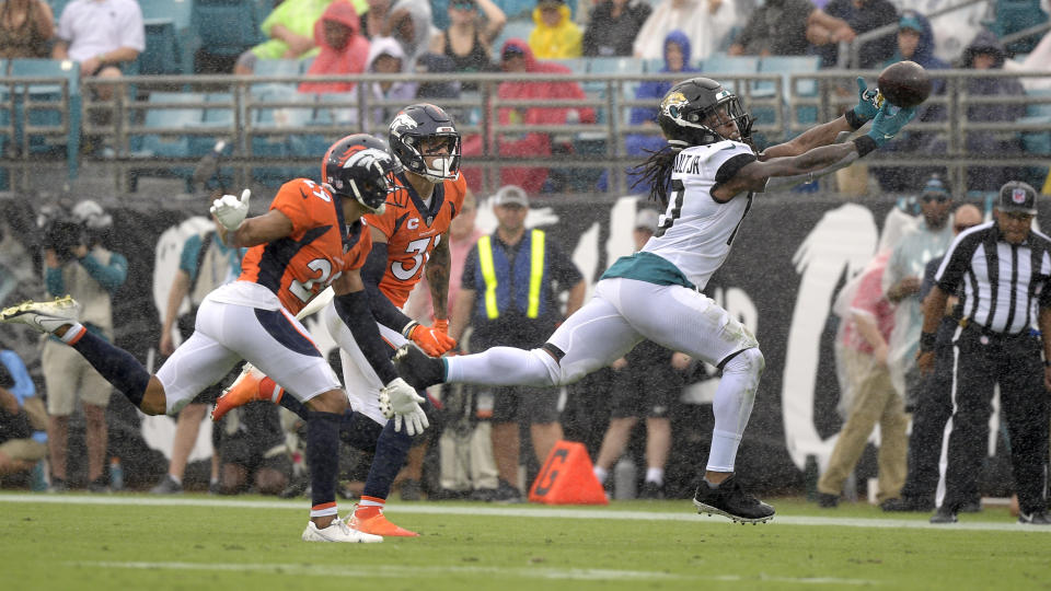 Jacksonville Jaguars wide receiver Laviska Shenault Jr., right, can't make a catch in front of Denver Broncos cornerback Bryce Callahan, left, and safety Justin Simmons, center, during the first half of an NFL football game, Sunday, Sept. 19, 2021, in Jacksonville, Fla. (AP Photo/Phelan M. Ebenhack)