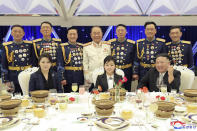 In this photo provided by the North Korean government, North Korean leader Kim Jong Un, front right, with his wife Ri Sol Ju, front left, and his daughter poses with military top officials for a photo at a feast to mark the 75th founding anniversary of the Korean People’s Army at an unspecified place in North Korea Tuesday, Feb. 7, 2023. Independent journalists were not given access to cover the event depicted in this image distributed by the North Korean government. The content of this image is as provided and cannot be independently verified. Korean language watermark on image as provided by source reads: "KCNA" which is the abbreviation for Korean Central News Agency. (Korean Central News Agency/Korea News Service via AP)