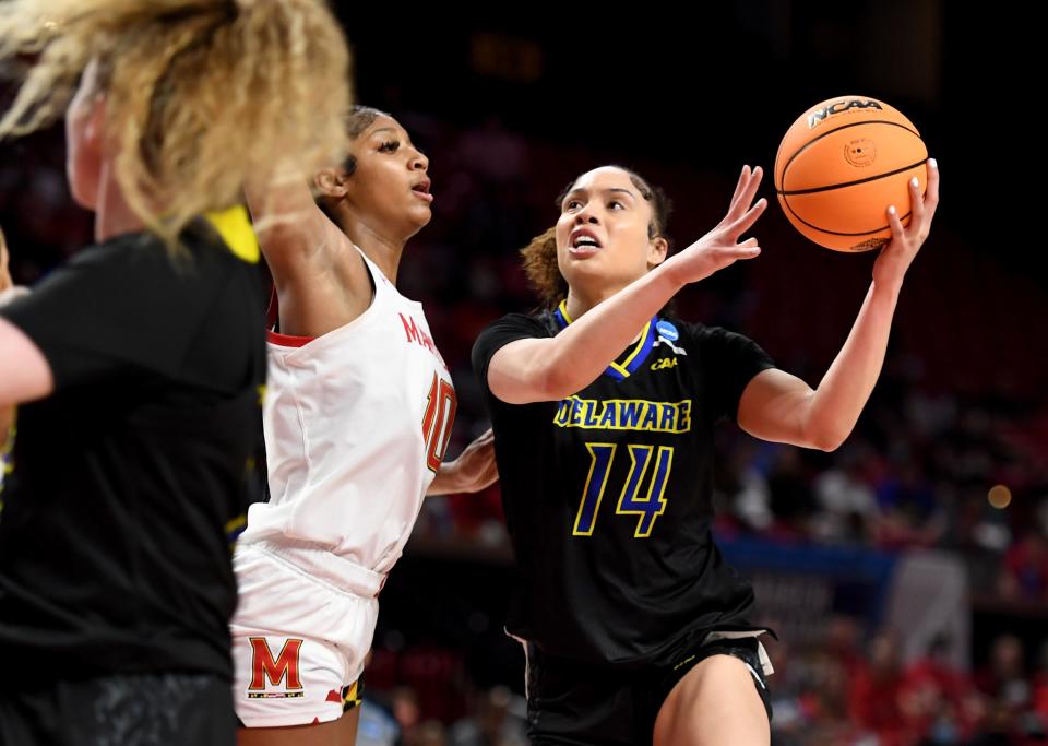 Delaware's MakaylaPippin (14) shoots by Maryland's Angel Reese (10) Friday, March 18, 2022, at the University of Maryland Xfinity Center in College Park, Maryland.