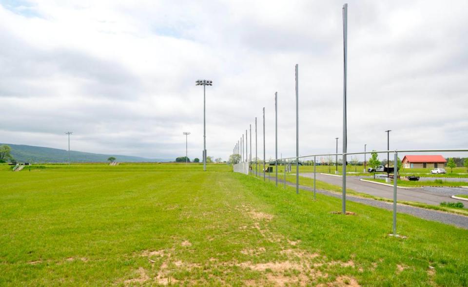 Fences are being installed along the premiere fields at Whitehall Road Regional Park on Tuesday.