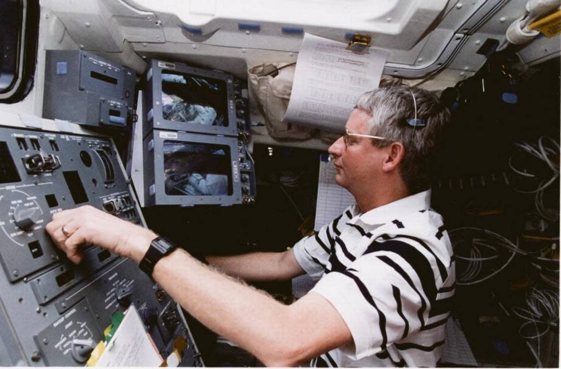 Astronaut, astronomer and Salina native Steve Hawley, aboard the space shuttle, operates a robotic arm attached to the Hubble Space Telescope.