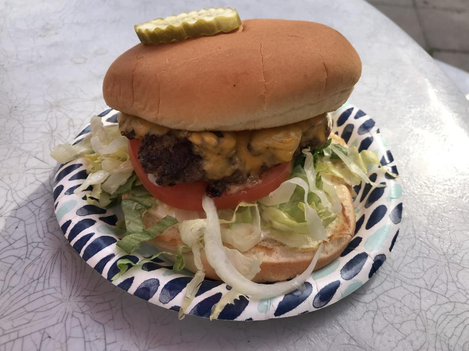 cheeseburger on paper plate from arctic roadrunner in alaska