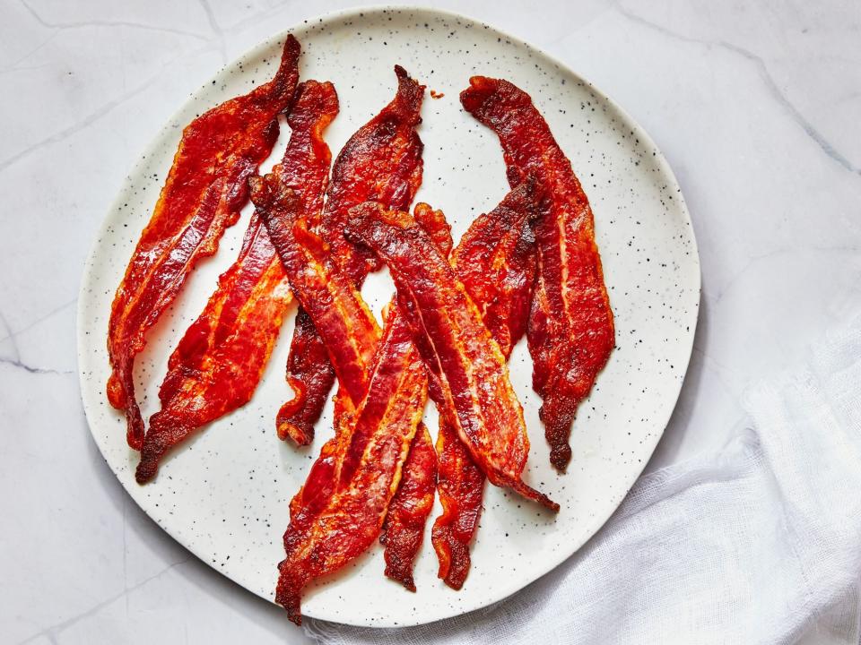 slices of cooked bacon on a white plate