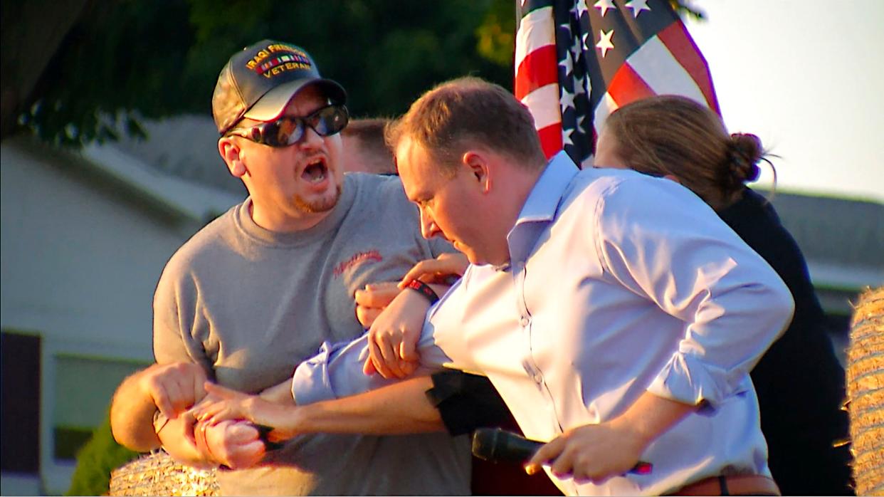 In this image taken from video provided by WHEC-TV, David Jakubonis, left, is subdued as he brandishes a sharp object during an attack U.S. Rep. Lee Zeldin, right, as the Republican candidate for New York governor delivered a speech in Perinton, N.Y., Thursday, July 21, 2022.
