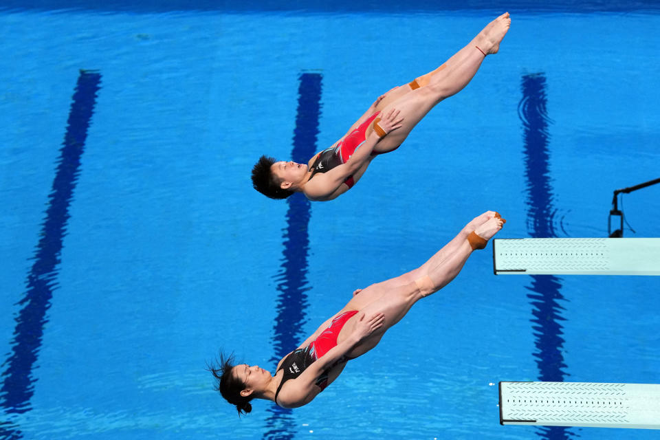 Yani Chang and Yiwen Chen of China compete during the women's synchronized 3m springboard diving final at the World Aquatics Championships in Doha, Qatar, Wednesday, Feb. 7, 2024. (AP Photo/Hassan Ammar)