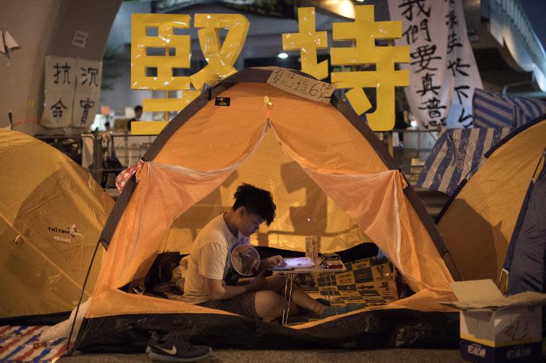 A pro-democracy protester sits in a tent in the Admiralty district of Hong Kong on October 22, 2014