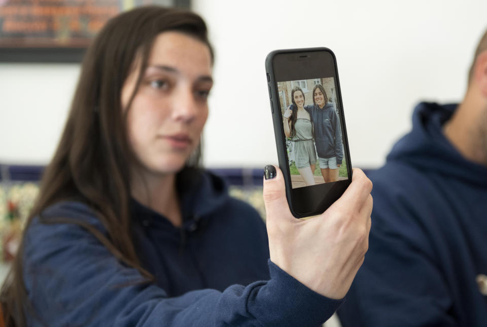 Olivia Kurtz shows a picture of her and her sister Allie, who lost her life on the dive boat Conception, during at interview with The Associated Press on Wednesday, Sept. 4, 2019 in Santa Barbara, Calif. A fire raged through the boat carrying recreational scuba divers anchored near an island off the Southern California Coast Monday, leaving multiple people dead. (AP Photo/Christian Monterrosa)