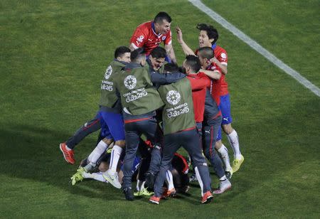 Chile players celebrate after defeating Argentina in their Copa America 2015 final soccer match at the National Stadium in Santiago, Chile, July 4, 2015. REUTERS/Ricardo Moraes