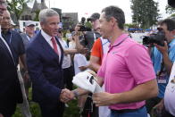 Rory McIlroy, front right, shakes hands with PGA Commissioner Jay Monahan after winning the Canadian Open golf tournament in Toronto, Sunday, June 12, 2022. (Frank Gunn/The Canadian Press via AP)