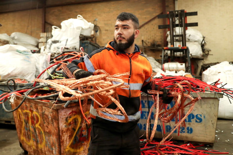 A worker prepares pure copper cables for export to China at a Sydney Copper Scraps facility in Sydney.