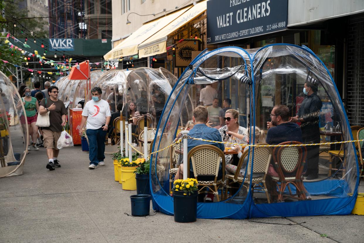 Guests enjoy dining in a space bubble at Cafe du Soleil on the Upper West Side in Manhattan, New York. The restaurant has installed 18 of the seven-foot-tall spheres. (Barry Williams)