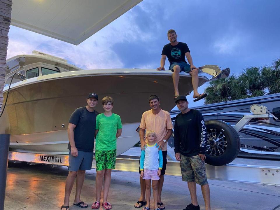 Joshua Yablon, Dylan Yablon, Tory Veigle, Beckham Veigle, Trey Krits and Drew McGucking stand by Veigle’s boat outside the Race Trac gas station and convenience store in Florida City Wednesday, July 28, 2021.