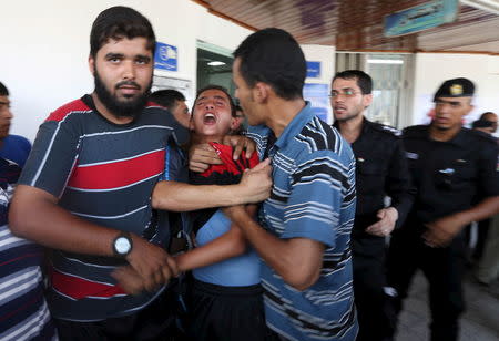 A relative of Palestinians, who were killed an explosion, mourns at a hospital in Rafah in the southern Gaza Strip August 6, 2015. REUTERS/Ibraheem Abu Mustafa