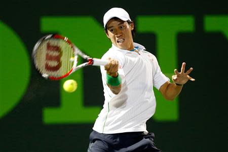 Mar 26, 2014; Miami, FL, USA; Kei Nishikori hits a forehand against Roger Federer (not pictured) on day ten of the Sony Open at Crandon Tennis Center. Geoff Burke-USA TODAY Sports