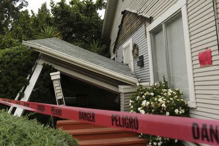 Red tape surrounds a home damaged by Sunday's magnitude 6.0 earthquake in Napa, California August 25, 2014. REUTERS/Robert Galbraith