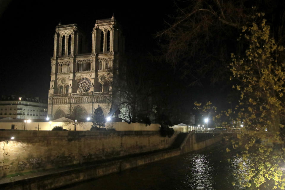 This photo taken on Monday Dec. 16, 2019 shows Notre Dame Cathedral lit up at night, in Paris. Notre Dame Cathedral kept holding services during two world wars as a beacon of hope amid bloodshed and fear. It took a fire in peacetime to finally stop Notre Dame from celebrating Christmas Mass for the first time in more than two centuries. (AP Photo/Michel Euler)