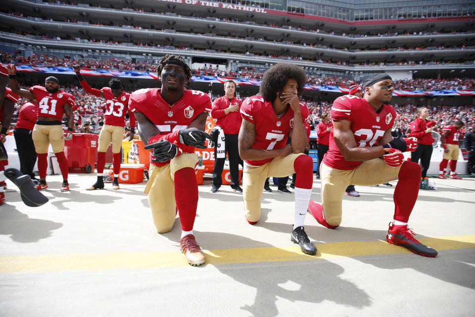 SANTA CLARA, CA - OCTOBER 2: Antoine Bethea #41 and Rashard Robinson #33  of the San Francisco 49ers raise their first during the anthem as Eli Harold #58 while teammates Colin Kaepernick #7 and Eric Reid #35 take a knee, prior to the game against the Dallas Cowboys at Levi Stadium on October 2, 2016 in Santa Clara, California. The Cowboys defeated the 49ers 24-17. (Photo by Michael Zagaris/San Francisco 49ers/Getty Images) 