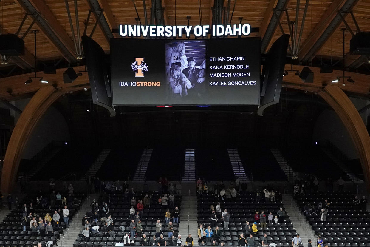 FILE - A photo and the names of four University of Idaho students who were killed over the weekend at a residence near campus are displayed during a moment of silence, Nov. 16, 2022, before an NCAA college basketball game in Moscow, Idaho. The Moscow Police Department has yet to name a person of interest in the stabbing deaths of the students . (AP Photo/Ted S. Warren, File)