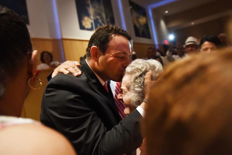 Paterson's Mayor Andre Sayegh kisses his mother Raymonde Sayegh during the City of Paterson Inaugural Ceremony 2018 at the International High School in Paterson on 07/01/18.