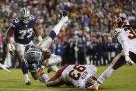 <p>Dallas Cowboys quarterback Dak Prescott (4) dives over Washington Redskins defensive end Jonathan Allen (93) for a touchdown during the second half of an NFL football game, Sunday, Oct. 21, 2018 in Landover, Md. (AP Photo/Andrew Harnik) </p>