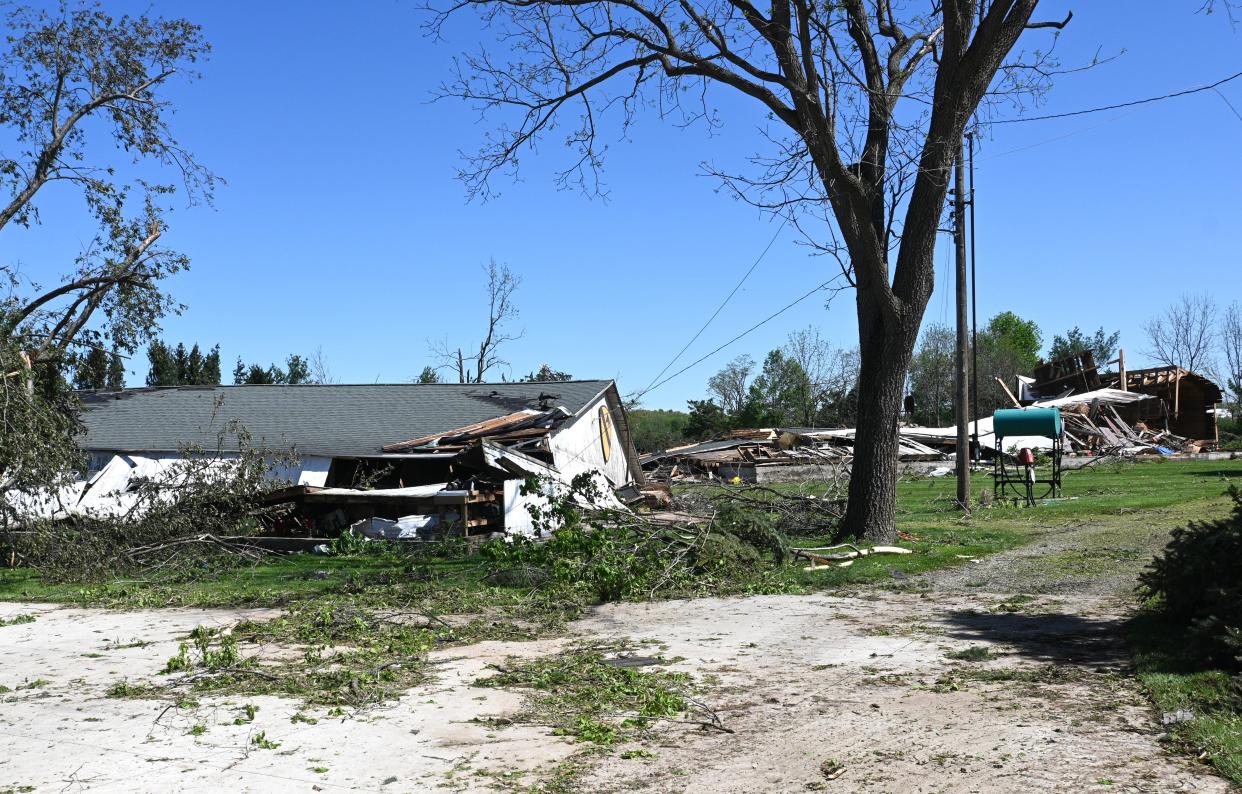 The tornado flattened Godfrey's pole barn while the 40-foot high 100-year-old two story barn in the background mostly disappeared.