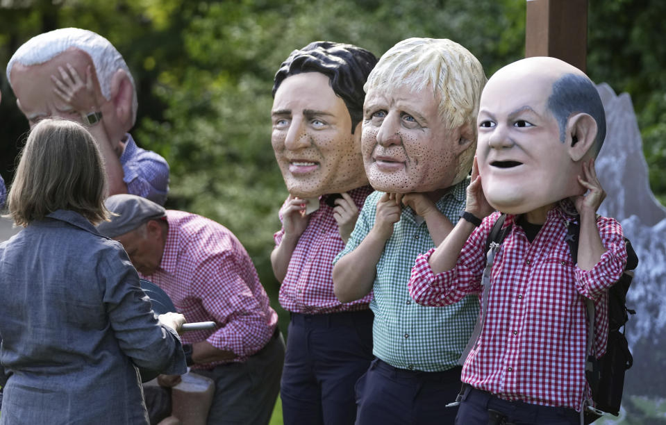 Activists from Oxfam wear giant heads depicting G7 leaders during a demonstration in Munich, Germany, Saturday, June 25, 2022. The G7 Summit will take place at Castle Elmau near Garmisch-Partenkirchen from June 26 through June 28, 2022. Leaders depicted from left, U.S. President Joe Biden, Canada's Prime Minister Justin Trudeau, British Prime Minister Boris Johnson and German Chancellor Olaf Scholz. (AP Photo/Matthias Schrader)