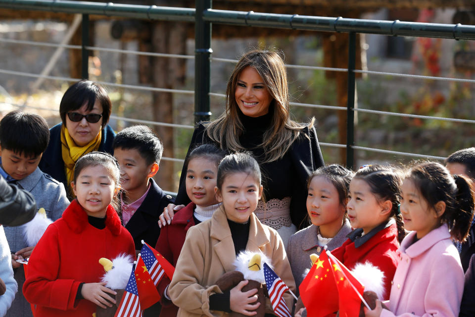 Melania Trump smiles with children holding U.S. and China flags as she visits Beijing Zoo.&nbsp;