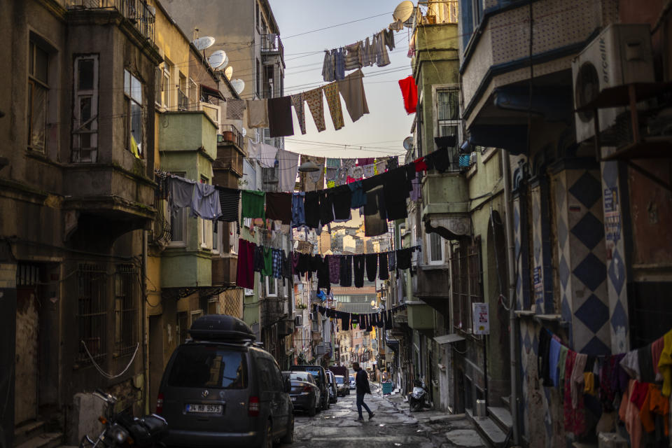 A man walks along a popular neighbourhood in Istanbul, Turkey, Monday, March 18, 2024. (AP Photo/Francisco Seco)