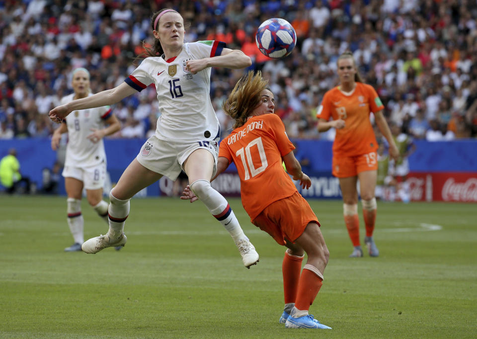 FILE - In this July 7, 2019, file photo, United States' Rose Lavelle, left, is challenged by Netherlands' Danielle Van De Donk during the Women's World Cup final soccer at the Stade de Lyon in Decines, outside Lyon, France. Twenty players have been named to the U.S. women's soccer team that will play for a spot in the Tokyo Olympics. Coach Andonovski announced the roster for the CONCACAF Olympic qualifying tournament Friday, Jan. 17, 2020. (AP Photo/David Vincent, File)