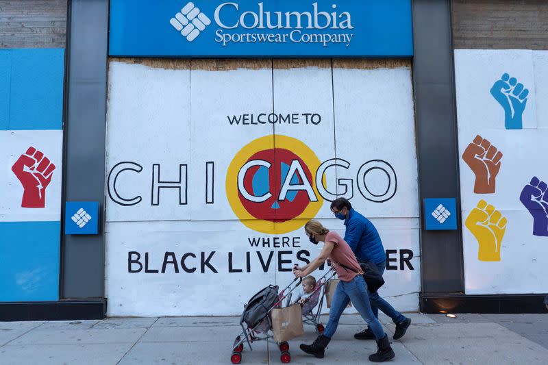 Plywood covers the window of a Columbia Sportswear Company store in Chicago