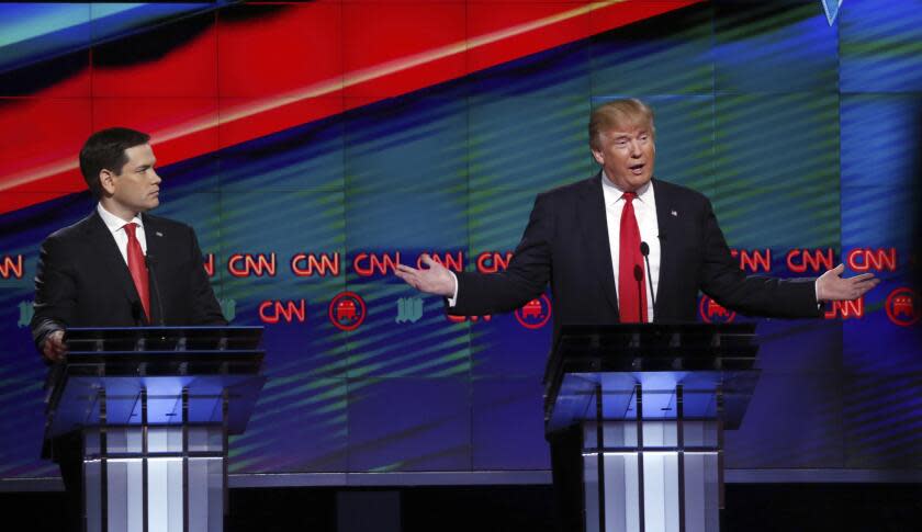 FILE - Republican presidential candidate, businessman Donald Trump, right, answers a question, as Republican presidential candidate, Sen. Marco Rubio, R-Fla., listens, during the Republican presidential debate at the University of Miami, March 10, 2016, in Coral Gables, Fla. Trump's norm-busting style carried him from reality TV to the White House, and he remade the party in his image along the way. But that style has befuddled those who try to run against him, especially now as they seek to win over some of his supporters rather than draw their ire. (AP Photo/Wilfredo Lee, File)