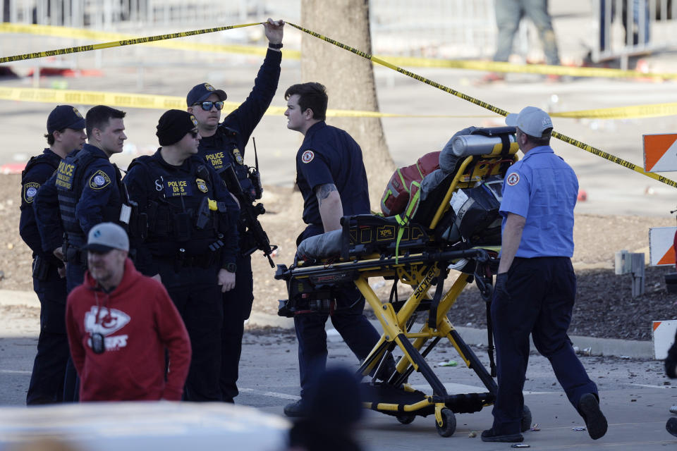 Emergency personnel arrive following a shooting at the Kansas City Chiefs NFL football Super Bowl celebration in Kansas City, Mo., Wednesday, Feb. 14, 2024. Multiple people were injured, a fire official said. (AP Photo/Charlie Riedel)