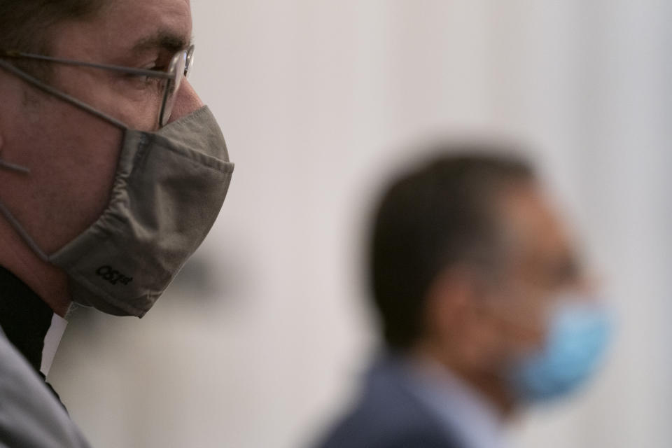 The Rev. Bob Lee, left, and Dr. Joseph Loconte, Associate Professor of History at The King's College in New York City, right, wear facemasks during a House Committee on Natural Resources, Subcommittee on National Parks, Forests, and Public Lands hearing on Capitol Hill in Washington, Tuesday, July 21, 2020, as they consider bills to remove Confederate statues. (AP Photo/Carolyn Kaster)