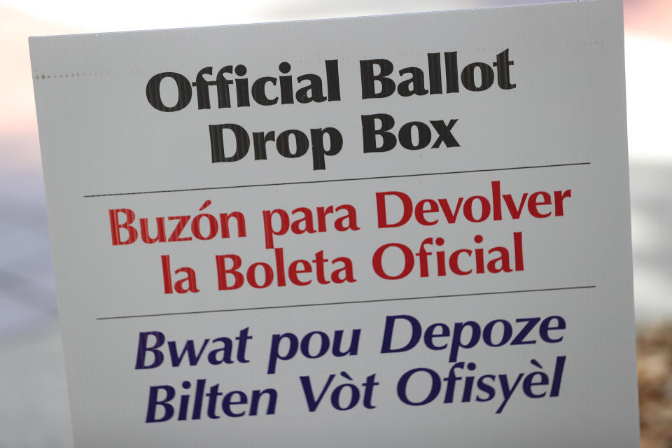 A sign directs voters to an official Miami-Dade County ballot drop box where they can cast their vote by placing their mail-in ballots inside the box on August 11, 2020 in Miami, Florida.  (Joe Raedle/Getty Images)