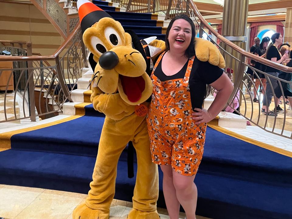 megan dubois posing with goofy character on disney dream