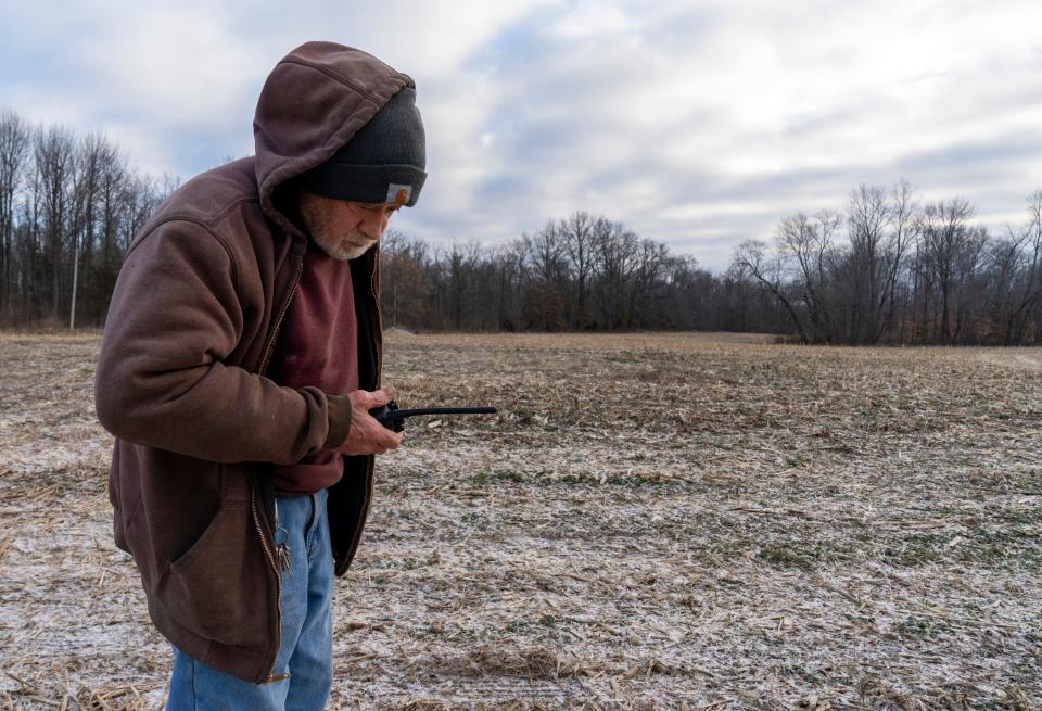 Joe Taft, Executive Director, uses a two-way radio to talk with a staff member on Sunday, Dec. 18, 2022, at Exotic Feline Rescue Center in Center Point, Ind. Taft, 77, stands on a one acre parcel of land that he’s planning to build five indoor/outdoor enclosures on, with an attached clinic for their cats. 