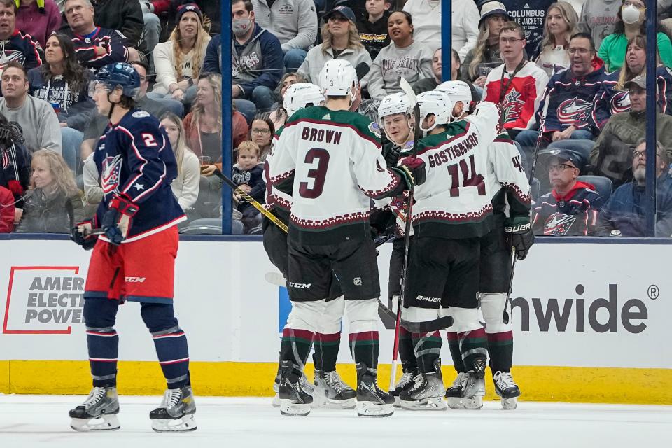 Oct 25, 2022; Columbus, Ohio, USA;  Arizona Coyotes celebrate a goal by right wing Zack Kassian (44) behind Columbus Blue Jackets defenseman Andrew Peeke (2) during the first period of the NHL hockey game at Nationwide Arena. Mandatory Credit: Adam Cairns-The Columbus Dispatch