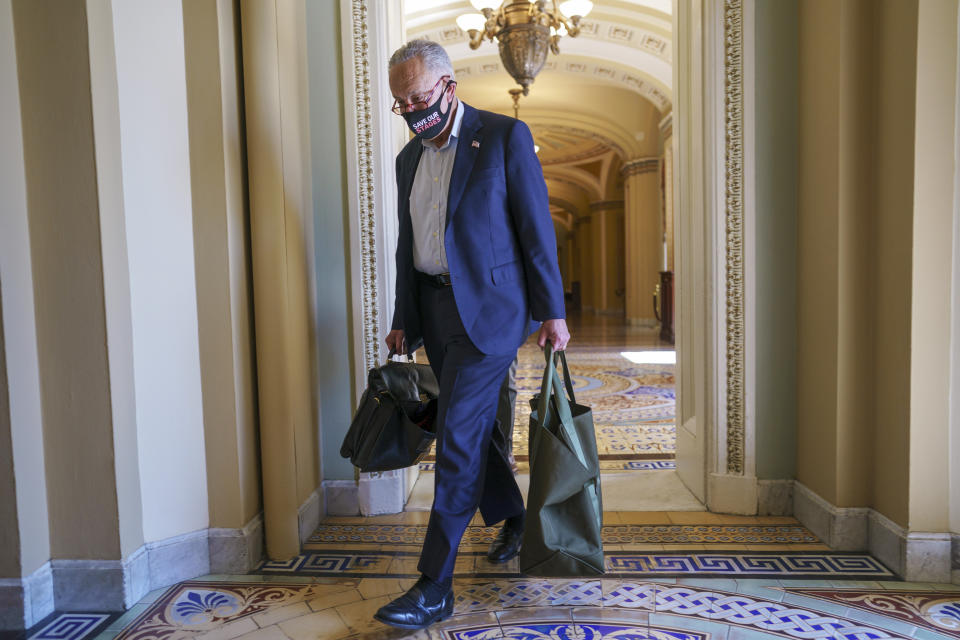 Senate Majority Leader Chuck Schumer, D-N.Y., arrives at the Capitol as a consequential week begins for President Joe Biden's agenda and Democratic leaders in Congress who are trying to advance his $3.5 trillion "Build Back Better" package and pass legislation to avoid a federal shutdown, in Washington, Monday, Sept. 27, 2021. (AP Photo/J. Scott Applewhite)