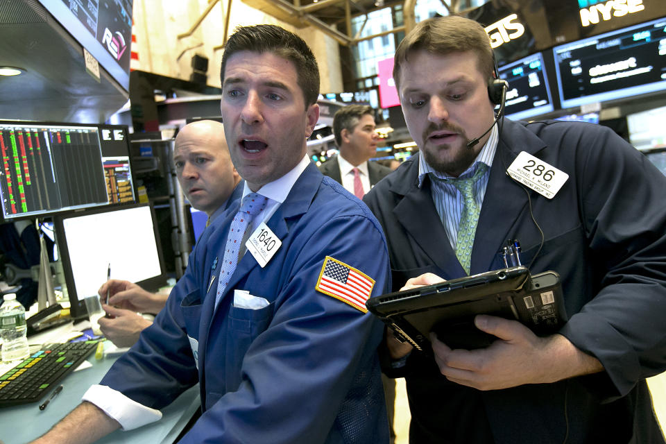 Specialist Thomas McArdle, center, and trader Michael Milano, right, work on the floor of the New York Stock Exchange, Wednesday, March 29, 2017. Stocks are opening mostly lower on Wall Street led by declines in utilities and real estate companies. (AP Photo/Richard Drew)