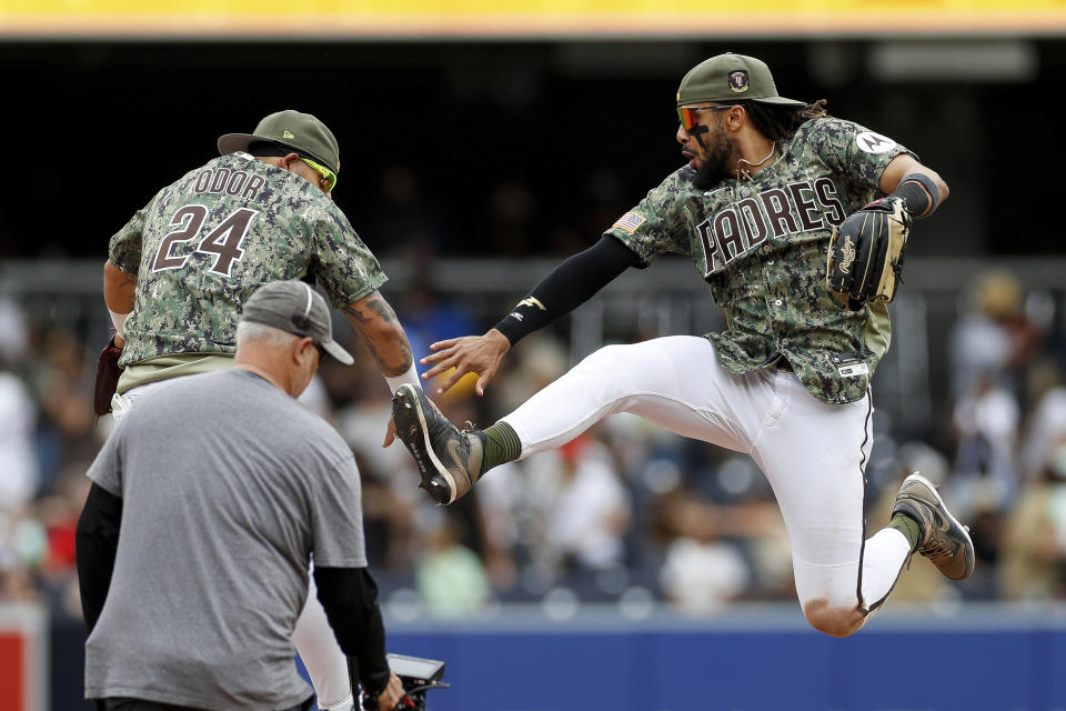 San Diego Padres' Fernando Tatis Jr. celebrates a team victory with Rougned Odor after the final out of a baseball game against the Boston Red Sox on Sunday, May 21, 2023, in San Diego. (AP Photo/Brandon Sloter)