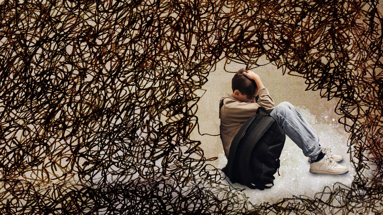 A seated child deep in thought, surrounded by a wire-like enclosure.