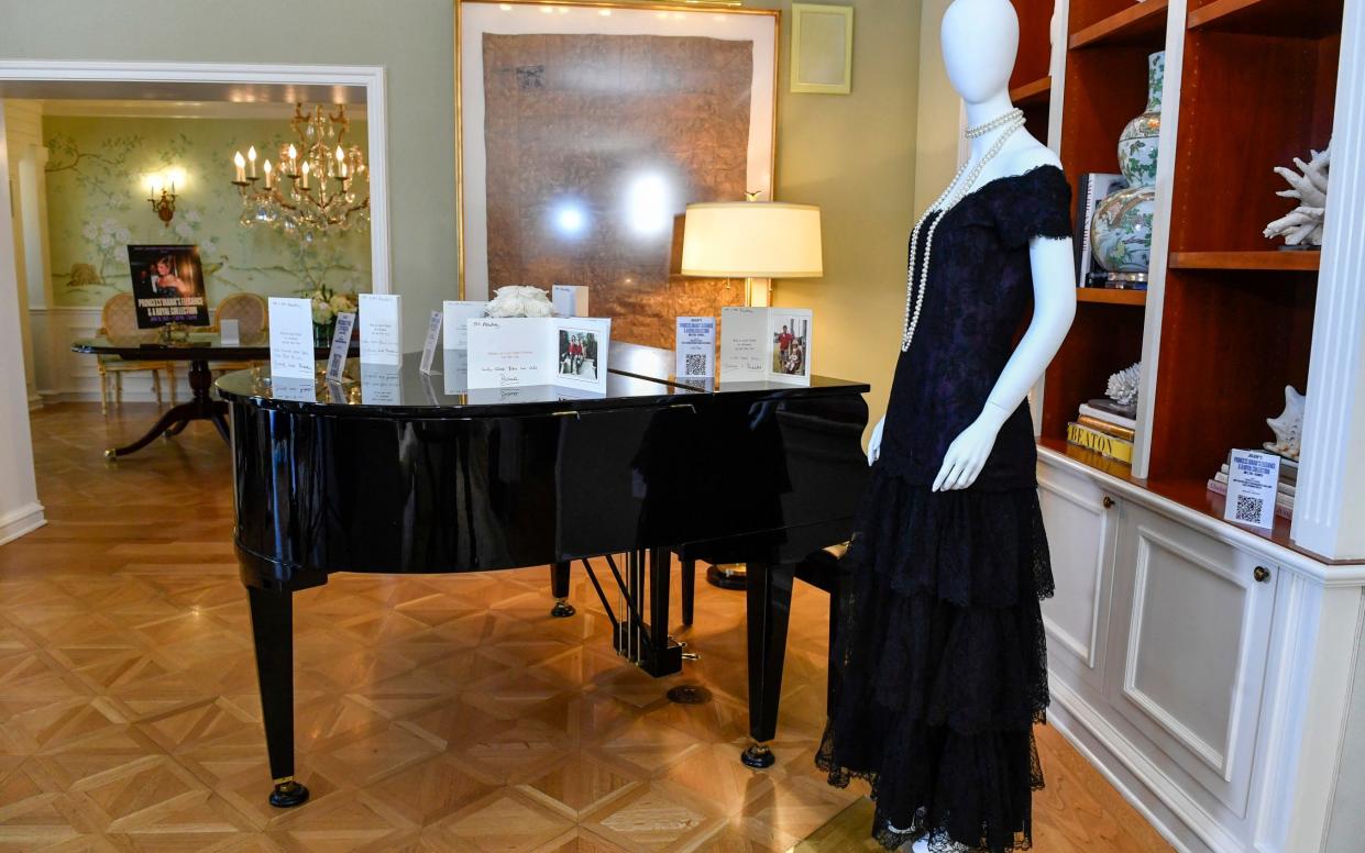 A 1987 Victor Edelstein magenta silk and lace evening dress owned by Princess Diana is displayed for the auction