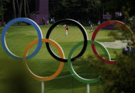 Austria's Sepp Straka, center, makes a putt on the 16th hole during the first round of the men's golf event at the 2020 Summer Olympics on Wednesday, July 28, 2021, at the Kasumigaseki Country Club in Kawagoe, Japan. (AP Photo/Matt York)