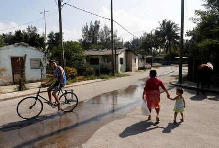 People go about their lives in Jaimanitas where Cuba's former President Fidel Castro lived in Havana, Cuba, December 2, 2016. Picture taken December 2, 2016. REUTERS/Stringer