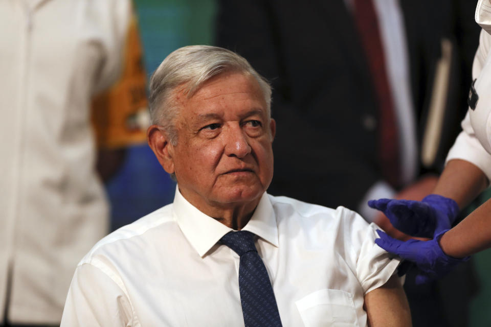 Mexican President Andres Manuel Lopez Obrador sits still moments after a nurse gave him a shot of the AstraZeneca vaccine for COVID-19 during his daily, morning news conference at the presidential palace in Mexico City, Tuesday, April 20, 2021. (AP Photo/Fernando Llano)