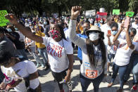 REMOVES “UNARMED” AND ADDS THAT AUTHORITIES HAVE NOT CONFIRMED THAT ARBERY WAS EITHER ARMED OR UNARMED - People react during a rally to protest the shooting of Ahmaud Arbery, Friday, May 8, 2020, in Brunswick Ga. Two men have been charged with murder in the February shooting death of Arbery, a black man in his mid-20s, whom they had pursued in a truck after spotting him running in their neighborhood. (AP Photo/John Bazemore)