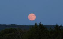 The Blue Moon full moon of July 2015 rises over the Ozarks near Ava, Missouri in this photo captured by skywatcher Debbie Wray.